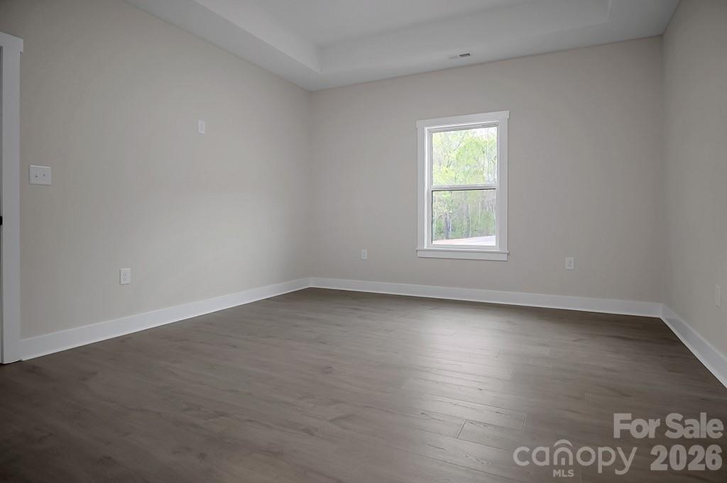 129 Rosecommon Lane Rutherfordton, NC 28139 - Photo 17 of 31 an empty room with wooden floor and windows