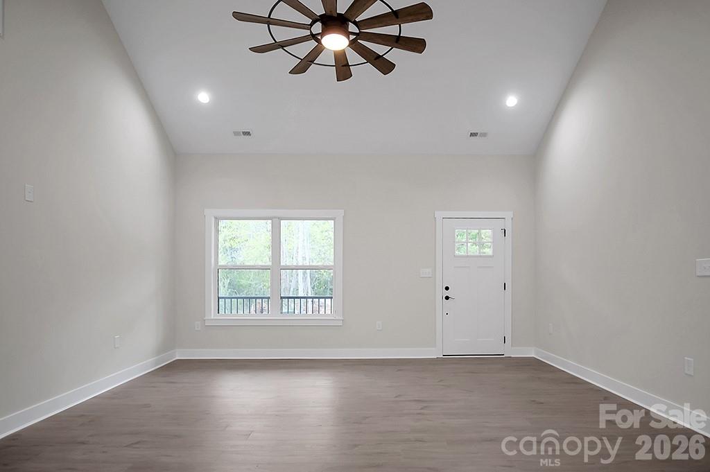 129 Rosecommon Lane Rutherfordton, NC 28139 - Photo 4 of 31 an empty room with windows and fan