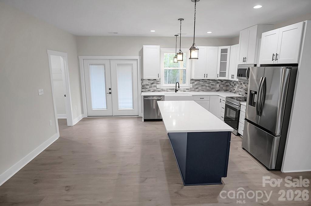 129 Rosecommon Lane Rutherfordton, NC 28139 - Photo 8 of 31 a kitchen with stainless steel appliances a refrigerator a sink a stove a kitchen island and cabinets
