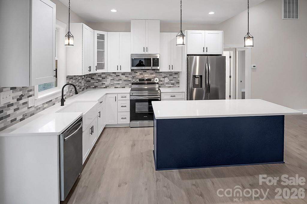 129 Rosecommon Lane Rutherfordton, NC 28139 - Photo 10 of 31 a large kitchen with a large counter top stainless steel appliances and cabinets