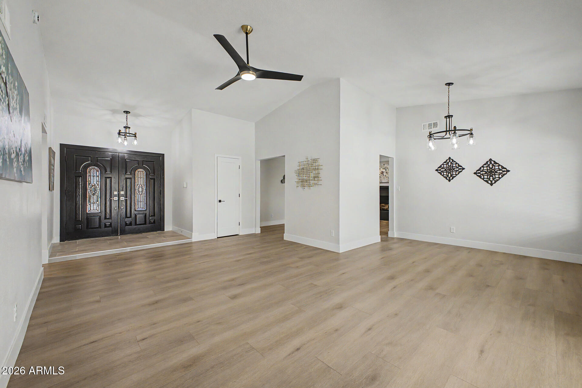 1009 West Pampa Avenue Mesa, AZ 85210 - Photo 4 of 31 an empty room with chandelier fan and windows