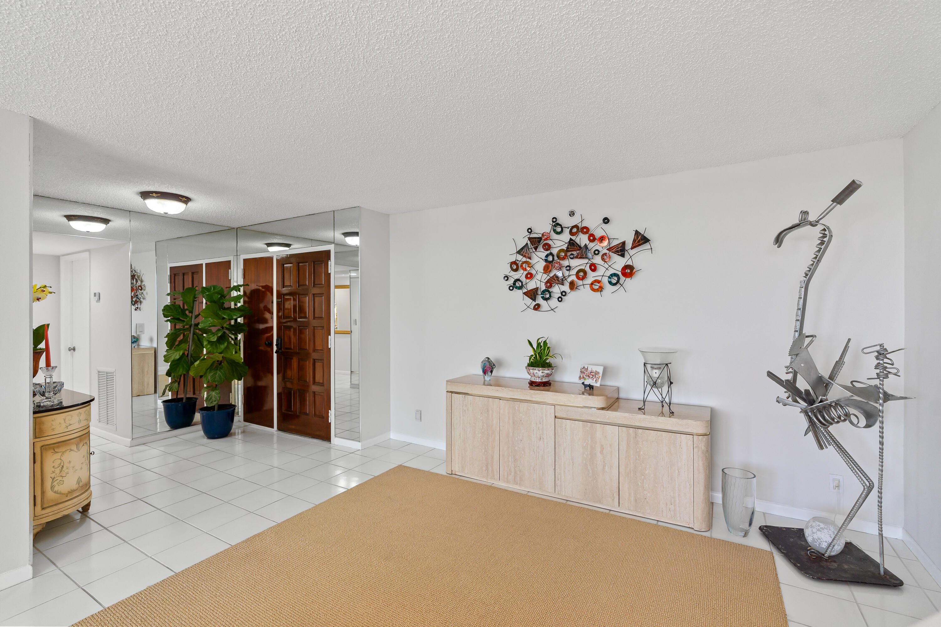 23200 Camino Del Mar, Unit 603 Boca Raton, FL 33433 - Photo 9 of 43 a living room with a couch and potted plant