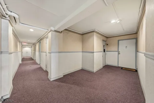 a view of a hallway with white walls