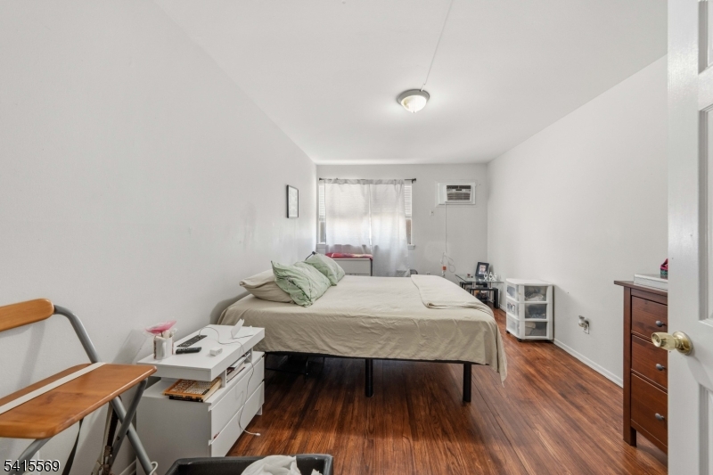 747 North Broad Street Elizabeth, NJ 07208 - Photo 6 of 13 a bedroom with a bed and a table