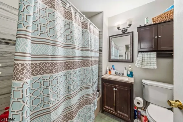 a bathroom with a sink a toilet and mirror