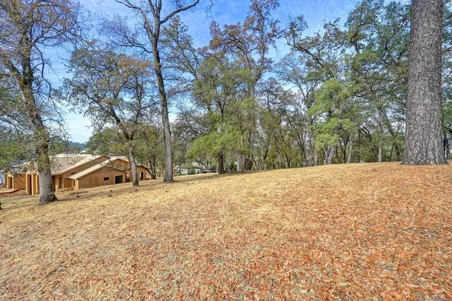 a view of white house with a snow in the yard