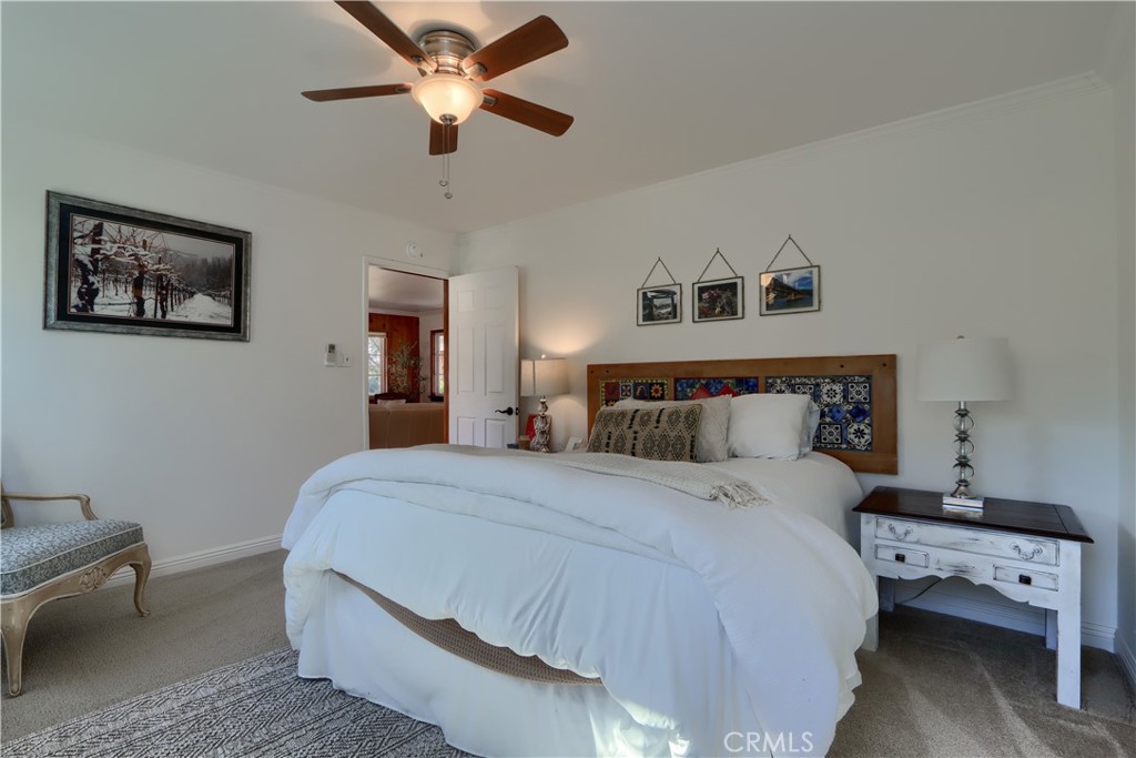 5641 Darrah Road Mariposa, CA 95338 - Photo 24 of 58 a bedroom with a bed and a chandelier