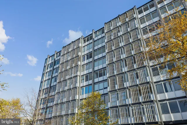 a kitchen with cabinets a sink and white appliances
