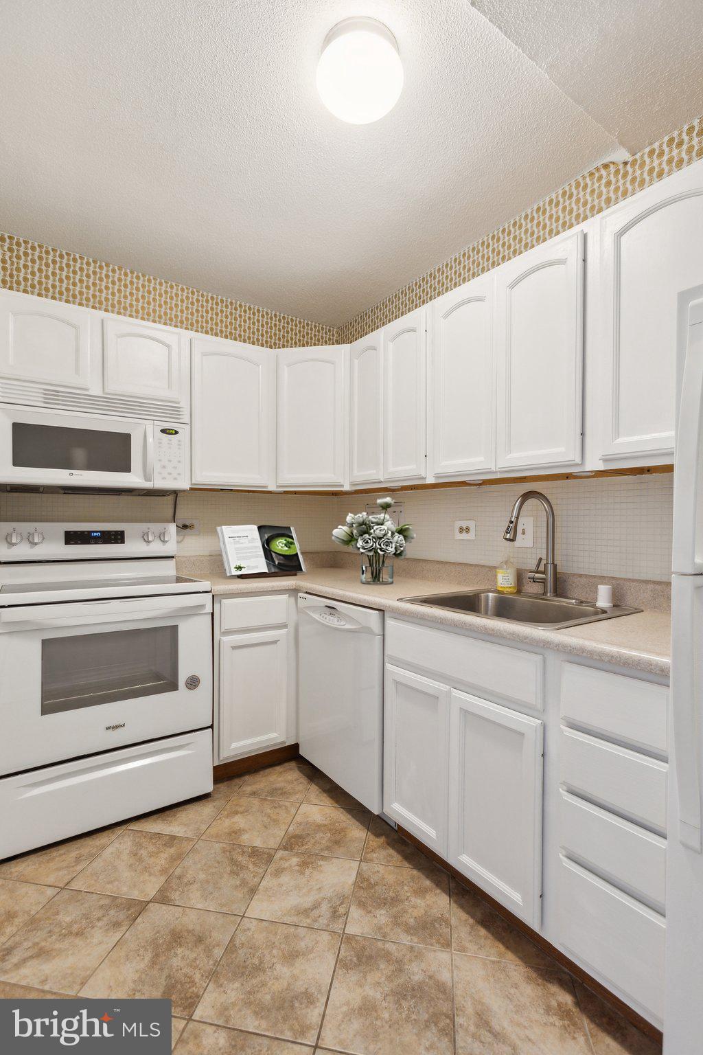 1301 Delaware Avenue Southwest, Unit N523 Washington, DC 20024 - Photo 3 of 25 a kitchen with granite countertop a sink and cabinets