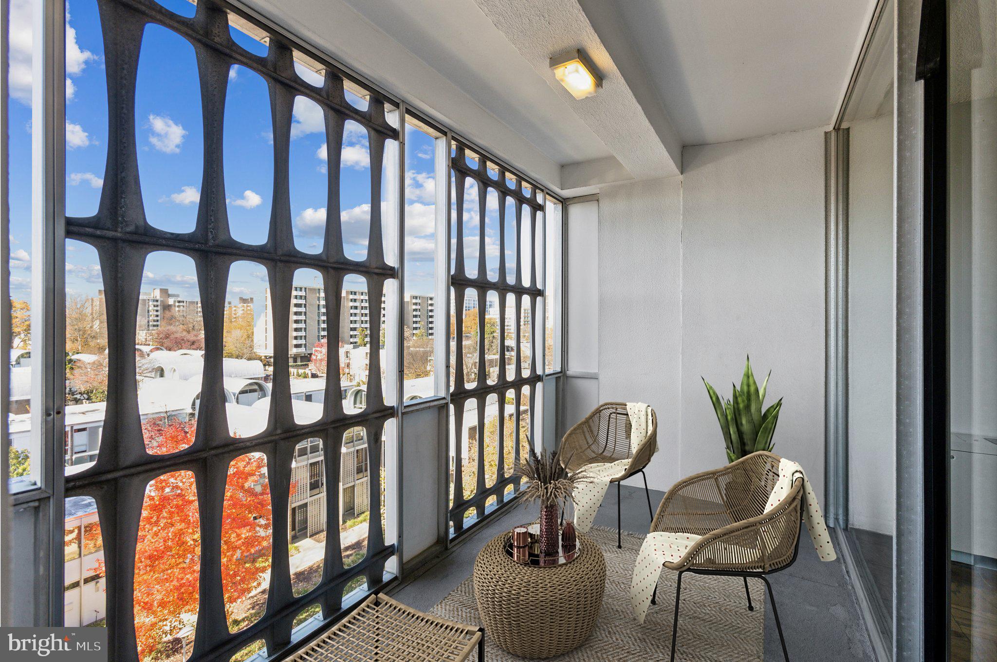 1301 Delaware Avenue Southwest, Unit N523 Washington, DC 20024 - Photo 5 of 25 a living room with furniture and a potted plant