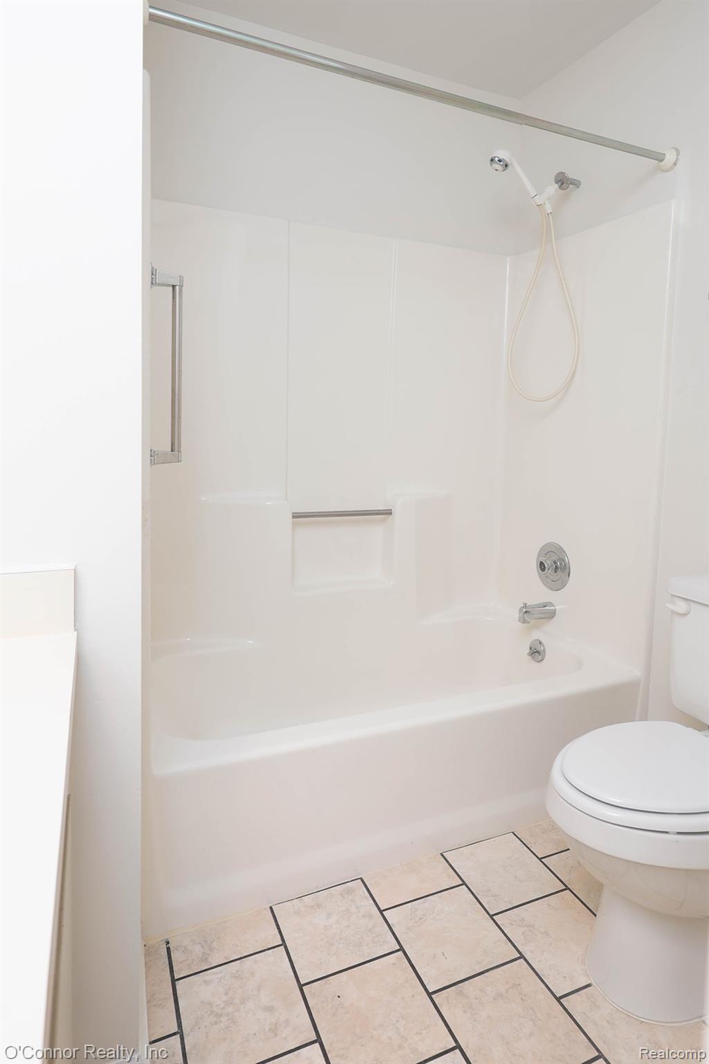 1660 River Road, Unit 53 Marysville, MI 48040 - Photo 24 of 31 Bathroom featuring shower / bathtub combination, vanity, and light tile patterned floors