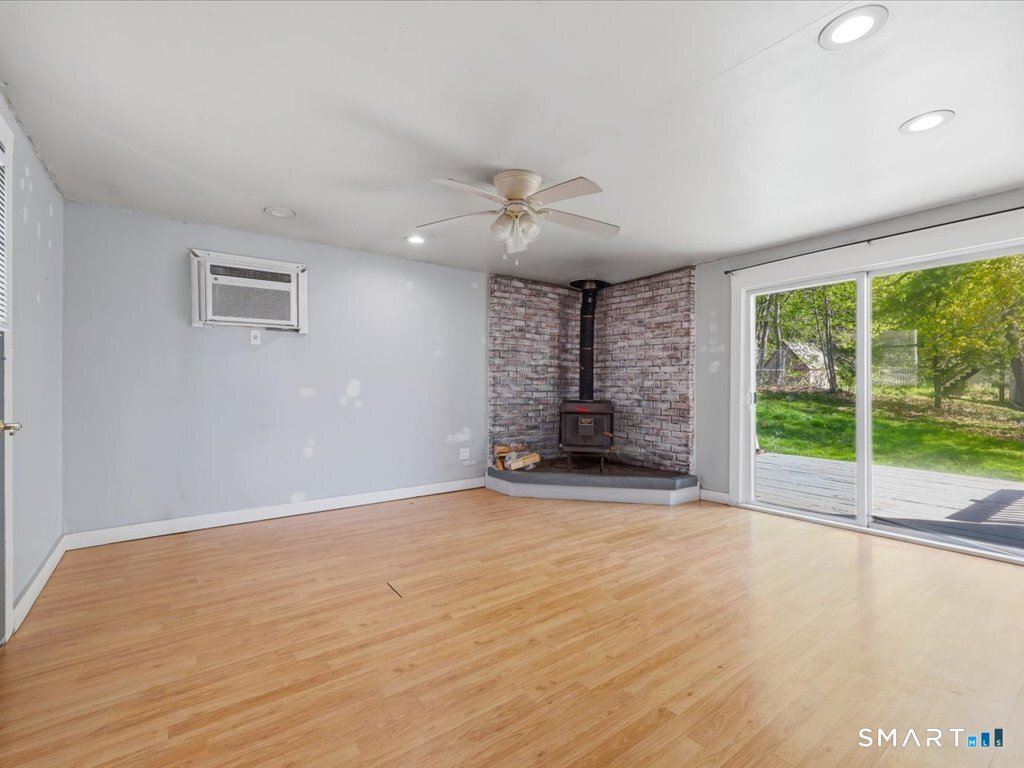 16 Grandview Terrace Portland, CT 06480 - Photo 14 of 37 a view of an empty room with a fireplace and a large window