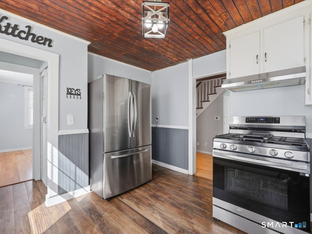16 Grandview Terrace Portland, CT 06480 - Photo 15 of 37 a kitchen with wooden floors and stainless steel appliances