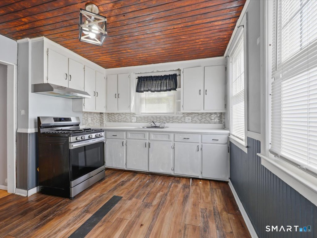 16 Grandview Terrace Portland, CT 06480 - Photo 17 of 37 a kitchen with stainless steel appliances granite countertop a stove a sink and white cabinets