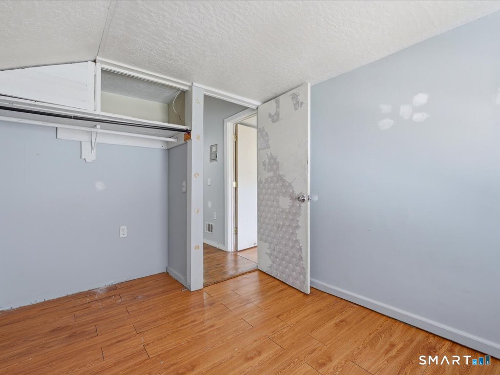 16 Grandview Terrace Portland, CT 06480 - Photo 29 of 37 a view of an empty room with wooden floor and a window