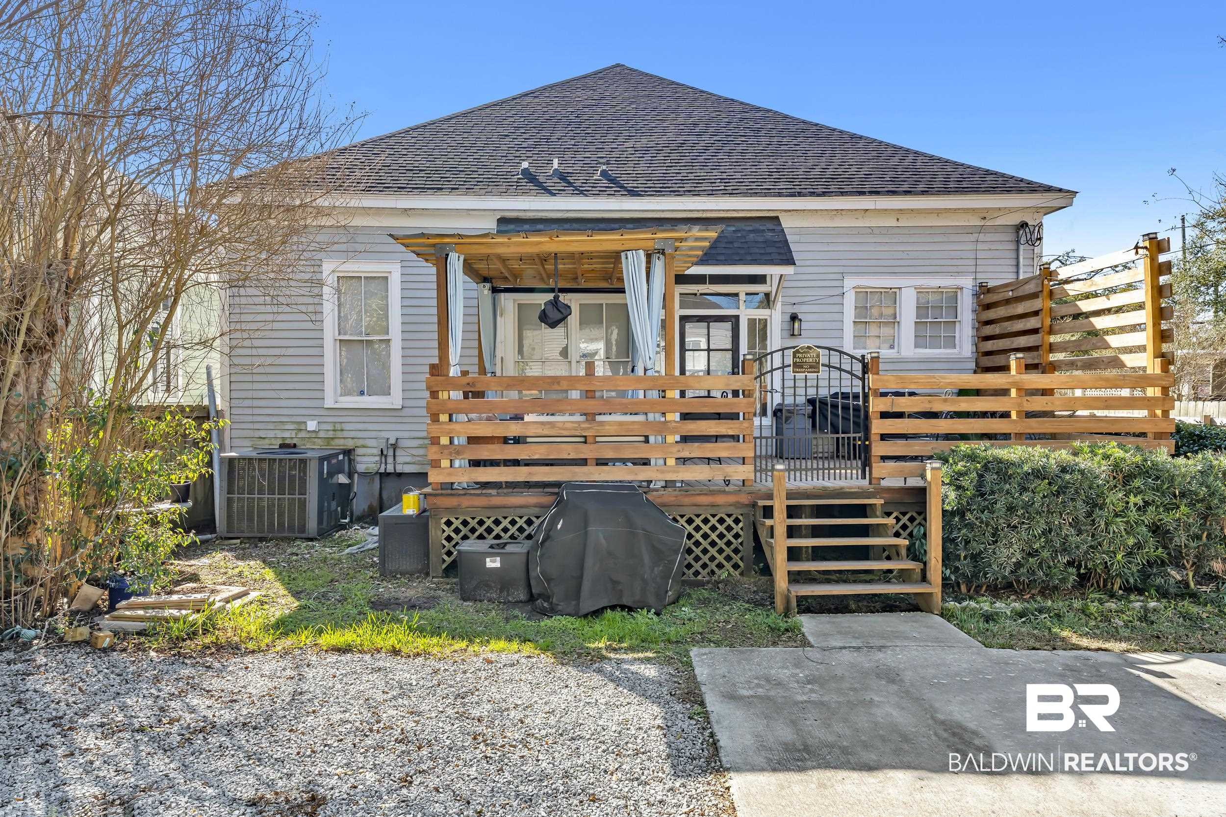 1322 Dauphin Street Mobile, AL 36604 - Photo 21 of 21 Rear view of house with a wooden deck and a shingled roof