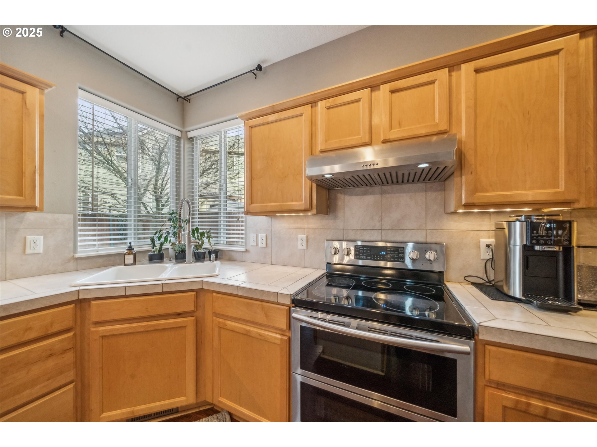 39697 Evans Street Sandy, OR 97055 - Photo 15 of 39 a kitchen with stainless steel appliances a stove a sink and a microwave