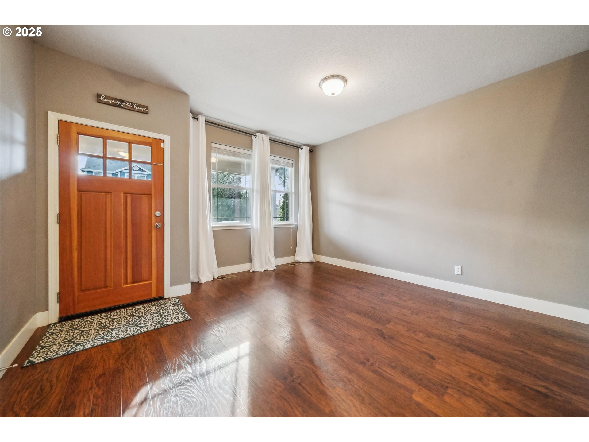 39697 Evans Street Sandy, OR 97055 - Photo 16 of 39 a view of an empty room with wooden floor and a window