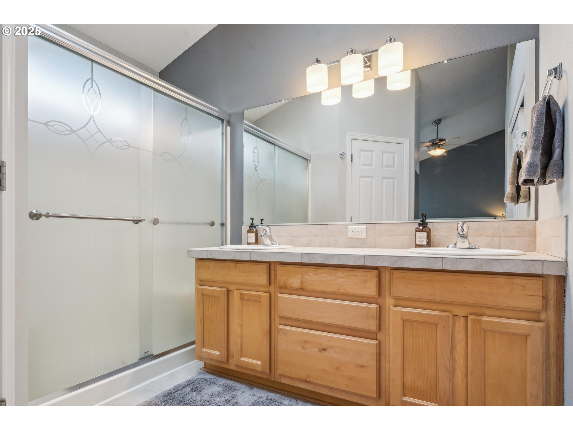 39697 Evans Street Sandy, OR 97055 - Photo 23 of 39 a bathroom with a sink a mirror and a shower