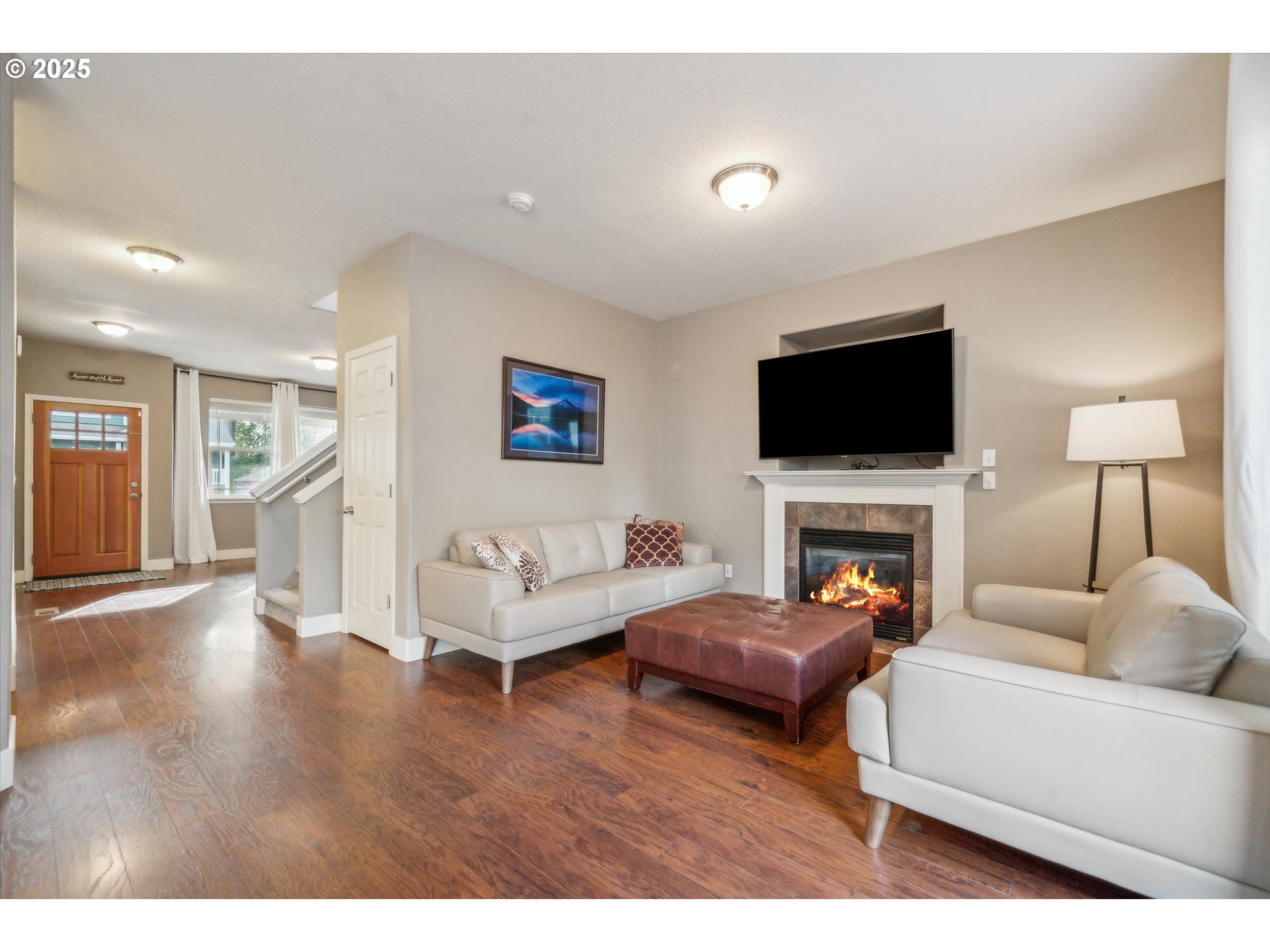 39697 Evans Street Sandy, OR 97055 - Photo 6 of 39 a living room with furniture a fireplace and a flat screen tv