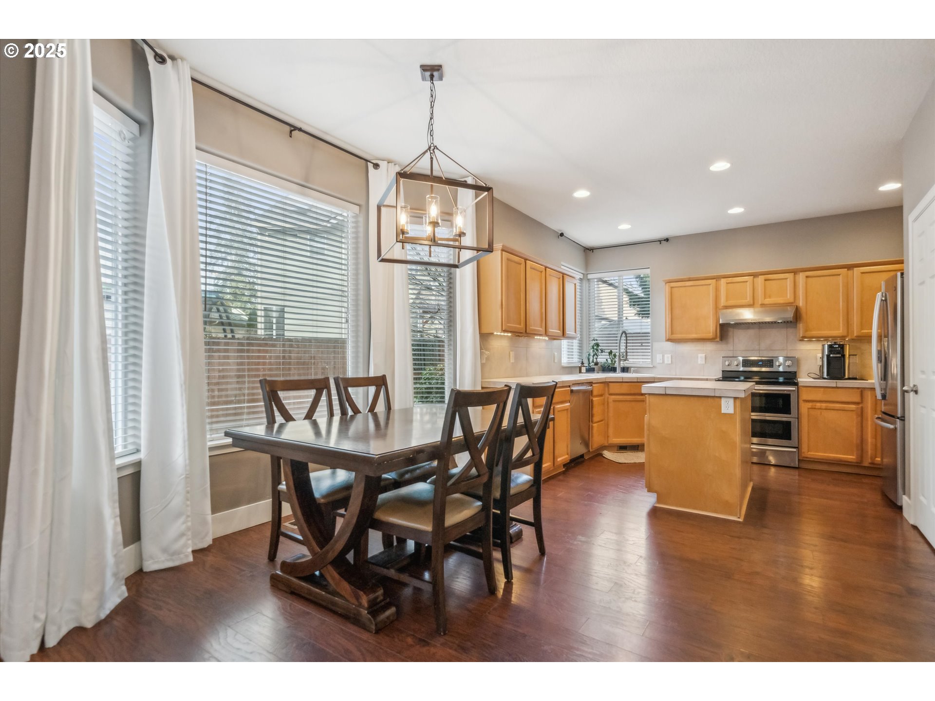 39697 Evans Street Sandy, OR 97055 - Photo 9 of 39 a dining room with stainless steel appliances kitchen island granite countertop a dining table chairs and granite counter tops