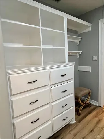 a view of walk in closet with empty racks