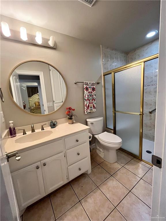 2113 South 3rd Street McAllen, TX 78503 - Photo 15 of 26 a bathroom with a toilet sink and mirror