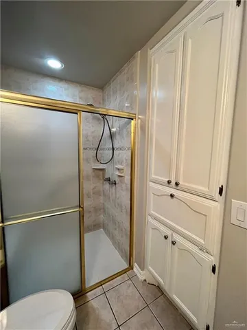a bathroom with a shower and toilet