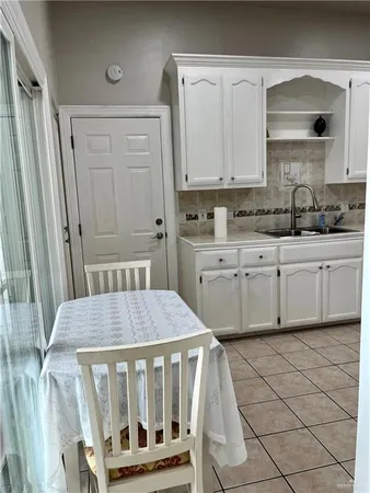 a kitchen with a sink cabinets and wooden floor