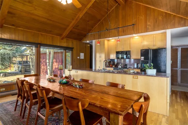 a kitchen with sink and large windows