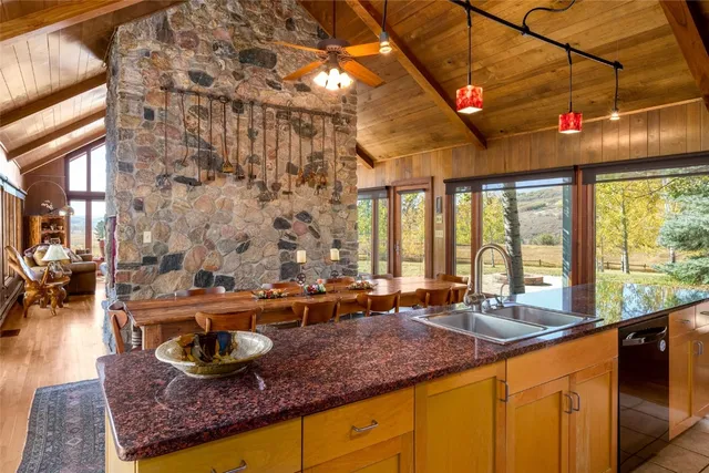 a kitchen with stainless steel appliances kitchen island granite countertop a sink and cabinets