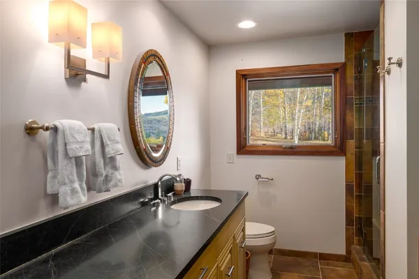 a living room with stainless steel appliances furniture and a view of kitchen