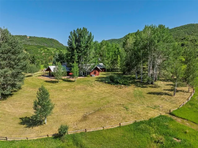 a view of a backyard with swimming pool