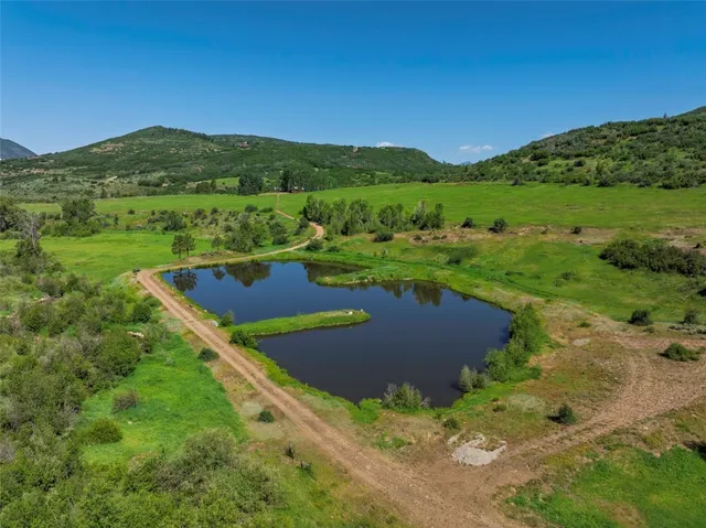 a view of a field with mountains in the background