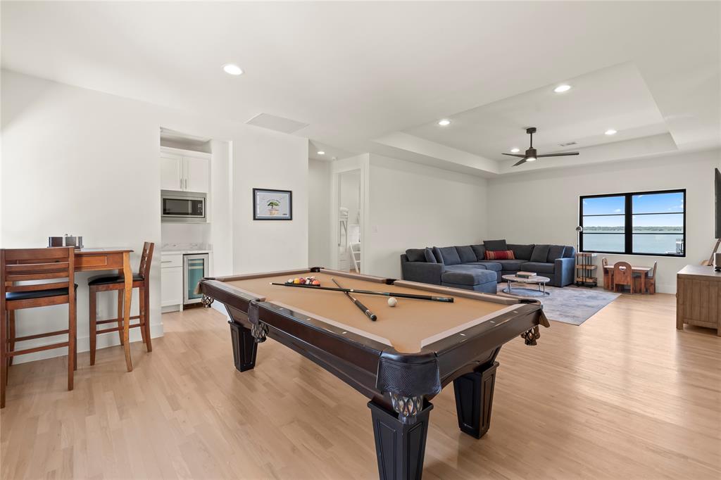 111 Sun Valley Mabank, TX 75147 - Photo 18 of 40 Spacious upstairs living area with sectional sofa, pool table, and stellar lake views!