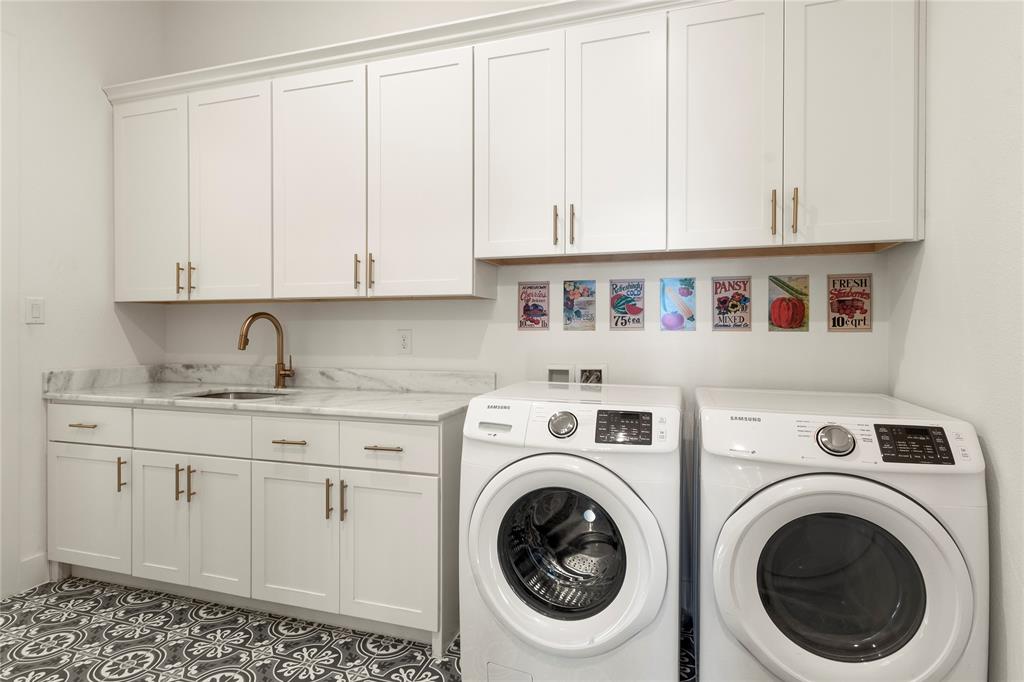 111 Sun Valley Mabank, TX 75147 - Photo 26 of 40 Utility room with sink, upper and lower cabinetry, and second refrigerator.