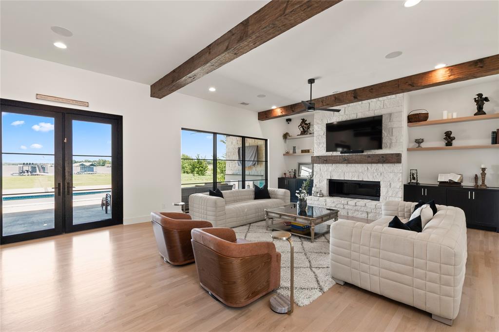 111 Sun Valley Mabank, TX 75147 - Photo 5 of 40 Open-concept great room filled with natural light from tall windows.