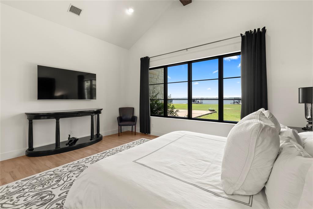 111 Sun Valley Mabank, TX 75147 - Photo 10 of 40 First primary suite with large windows overlooking the lake.