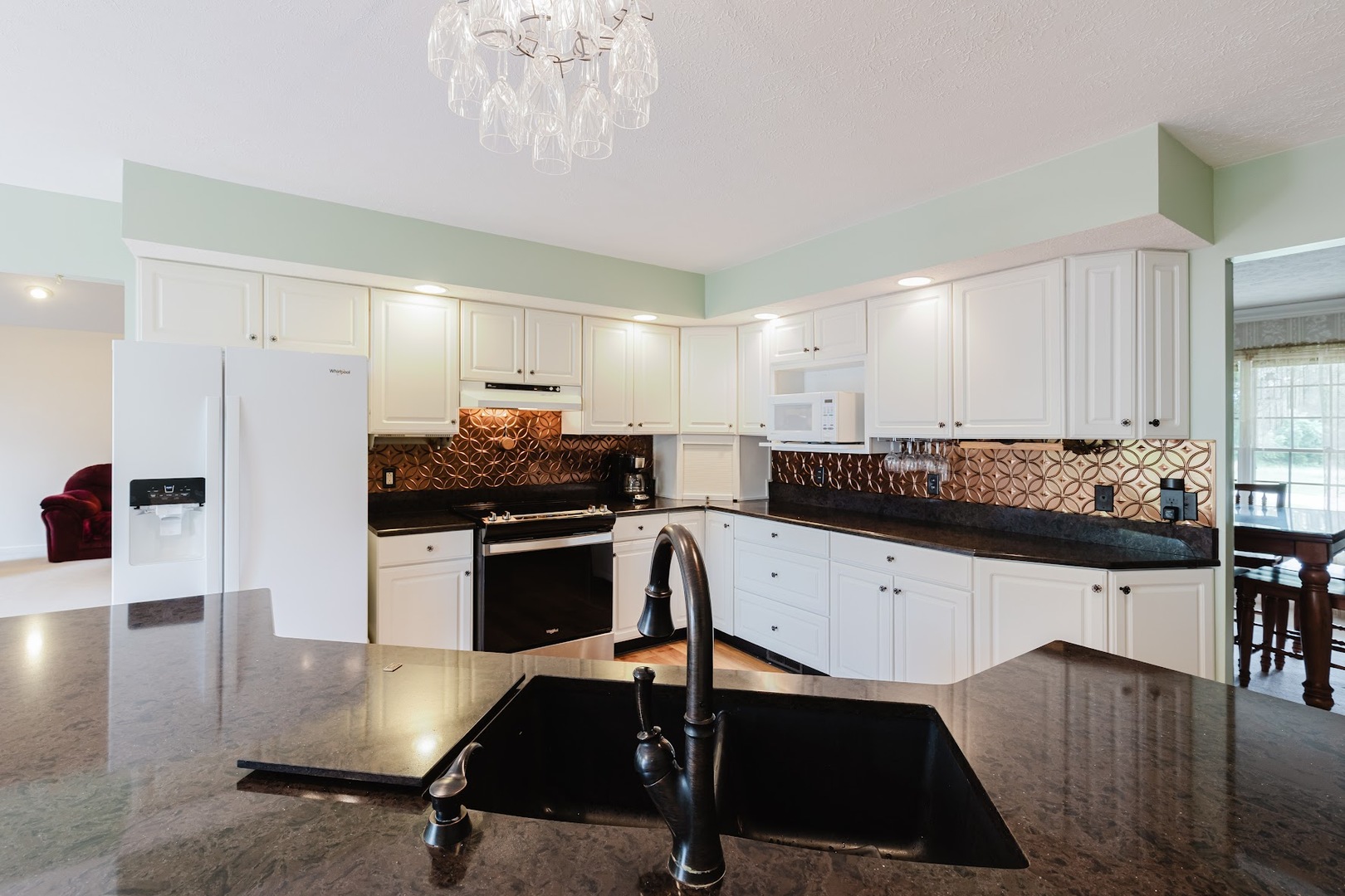 15136 Eastland Road Marion, IL 62959 - Photo 11 of 49 a kitchen with stainless steel appliances granite countertop a sink a stove and a refrigerator