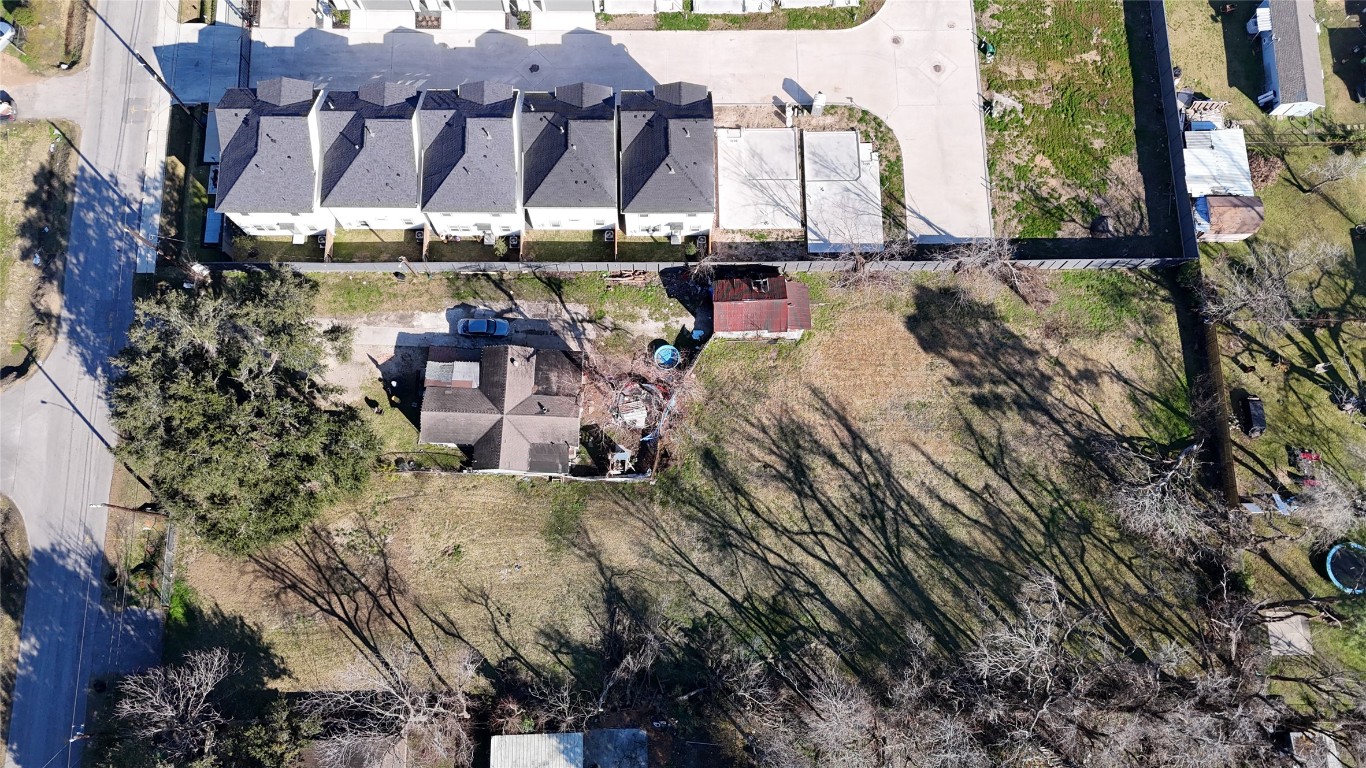 an aerial view of a house with a yard and mountain view in back
