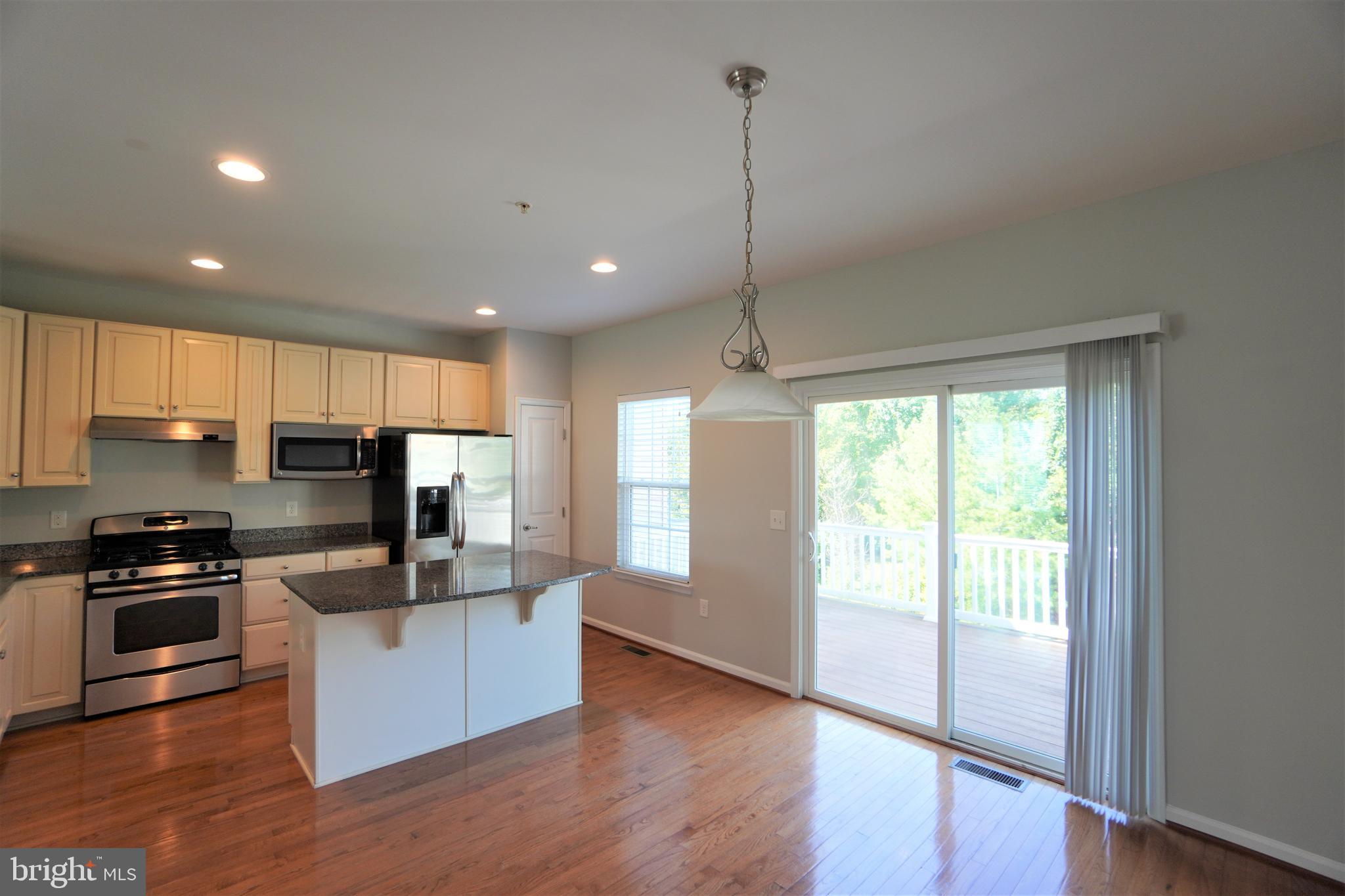 900 Susan Circle North Wales, PA 19454 - Photo 11 of 30 a kitchen with stainless steel appliances granite countertop a refrigerator a sink a stove and a wooden floors