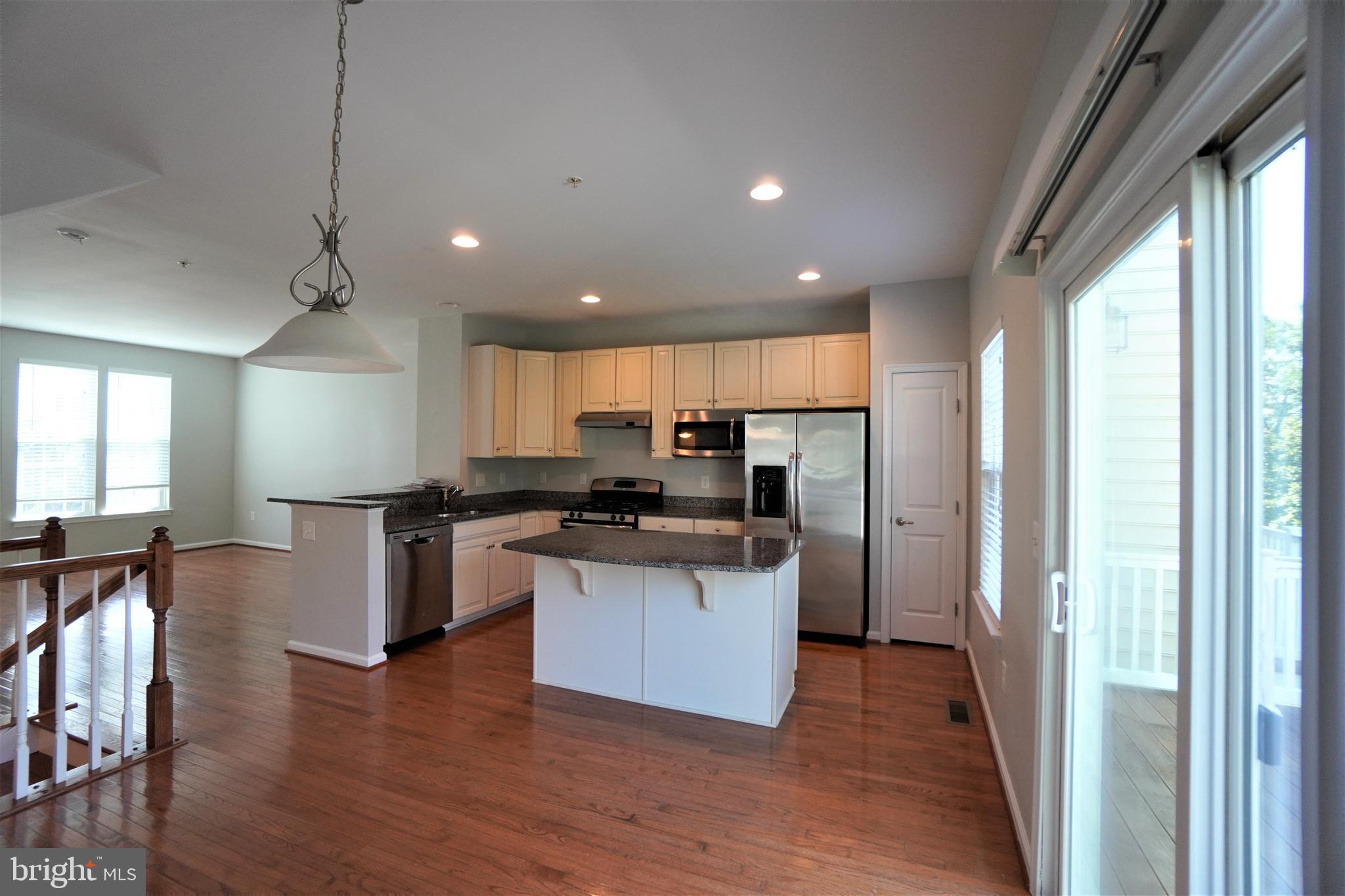 900 Susan Circle North Wales, PA 19454 - Photo 12 of 30 a kitchen with stainless steel appliances kitchen island granite countertop a stove and a refrigerator