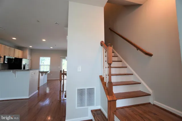 a view of entryway with wooden floor and stairs