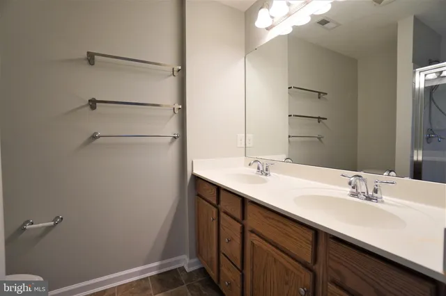 a bathroom with a sink double vanity and a mirror