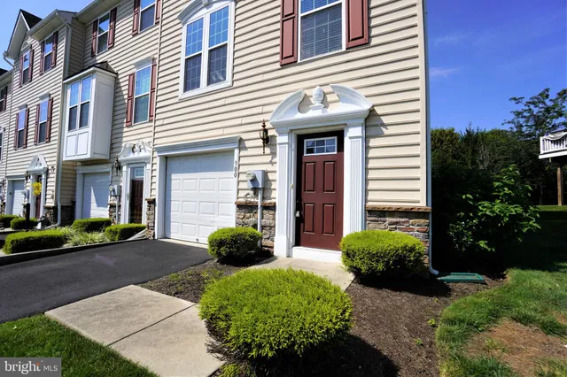 a view of a white house with a yard and plants