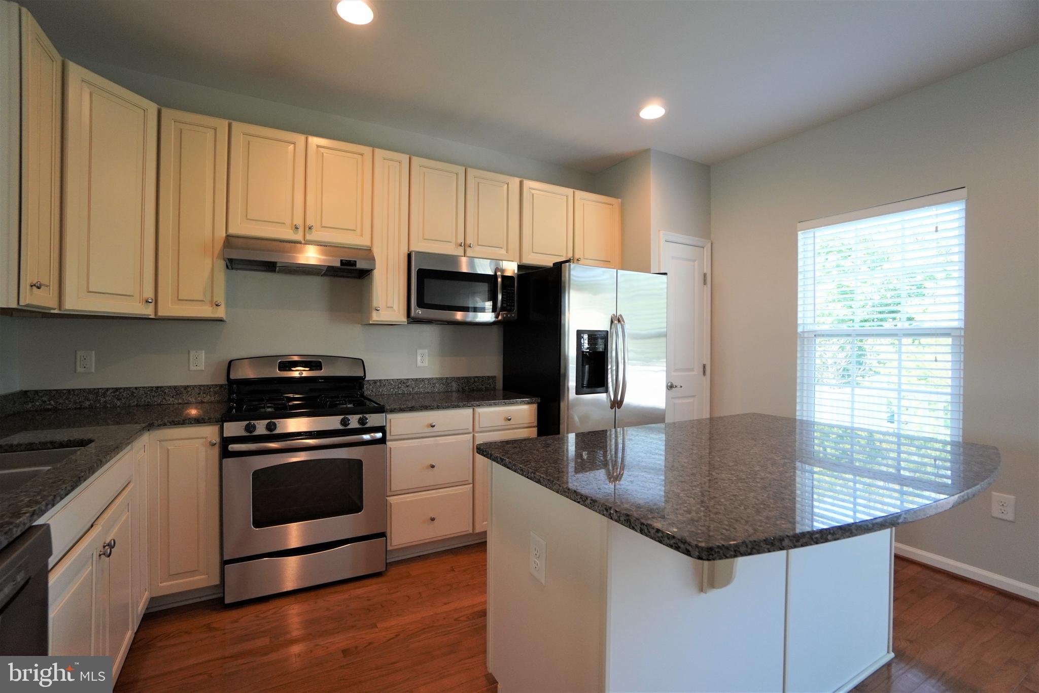 900 Susan Circle North Wales, PA 19454 - Photo 10 of 30 a kitchen with stainless steel appliances granite countertop a sink stove and refrigerator