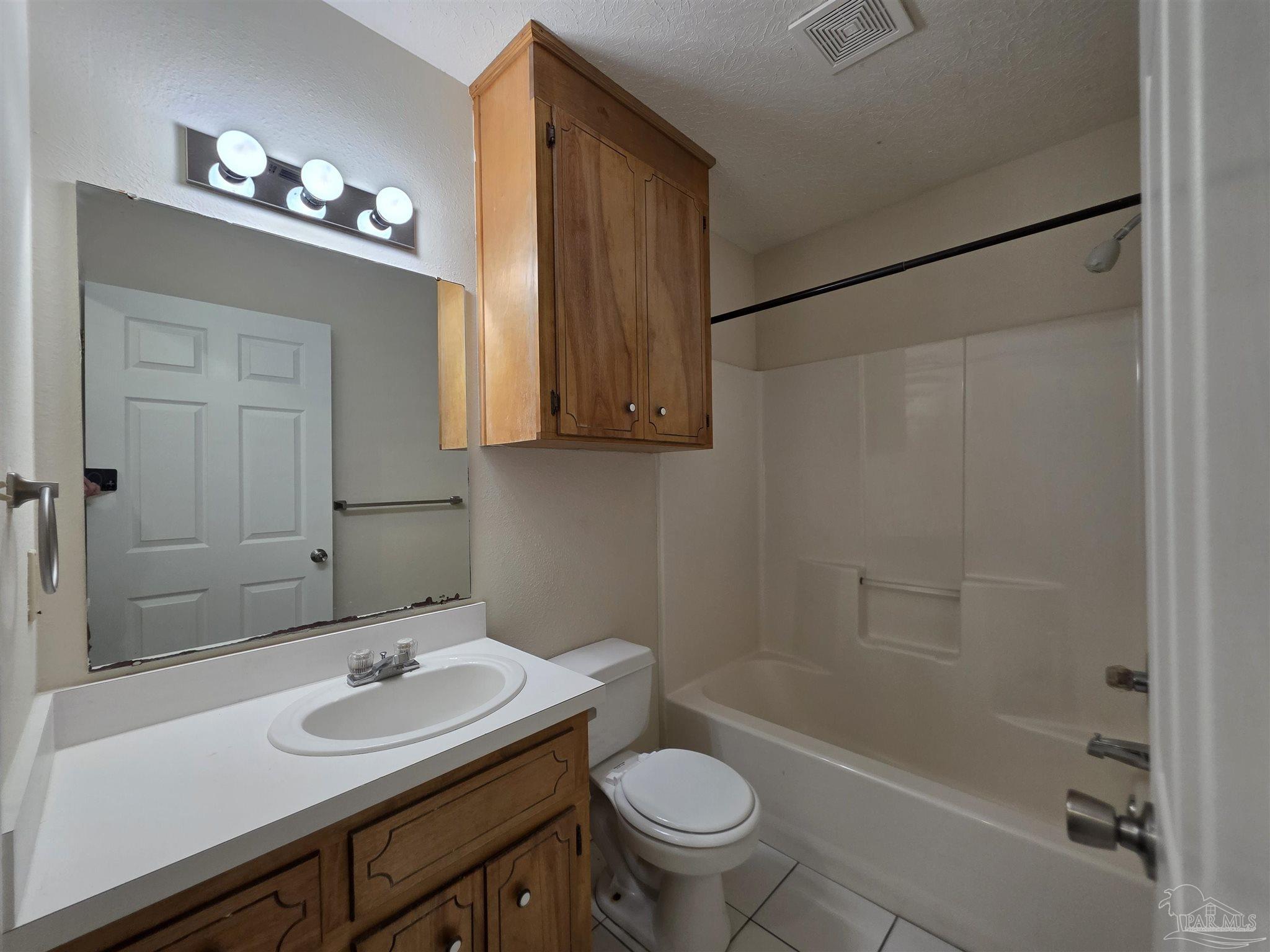 916 Rentz Avenue, Unit A Pensacola, FL 32507 - Photo 17 of 22 a bathroom with a sink a toilet and shower