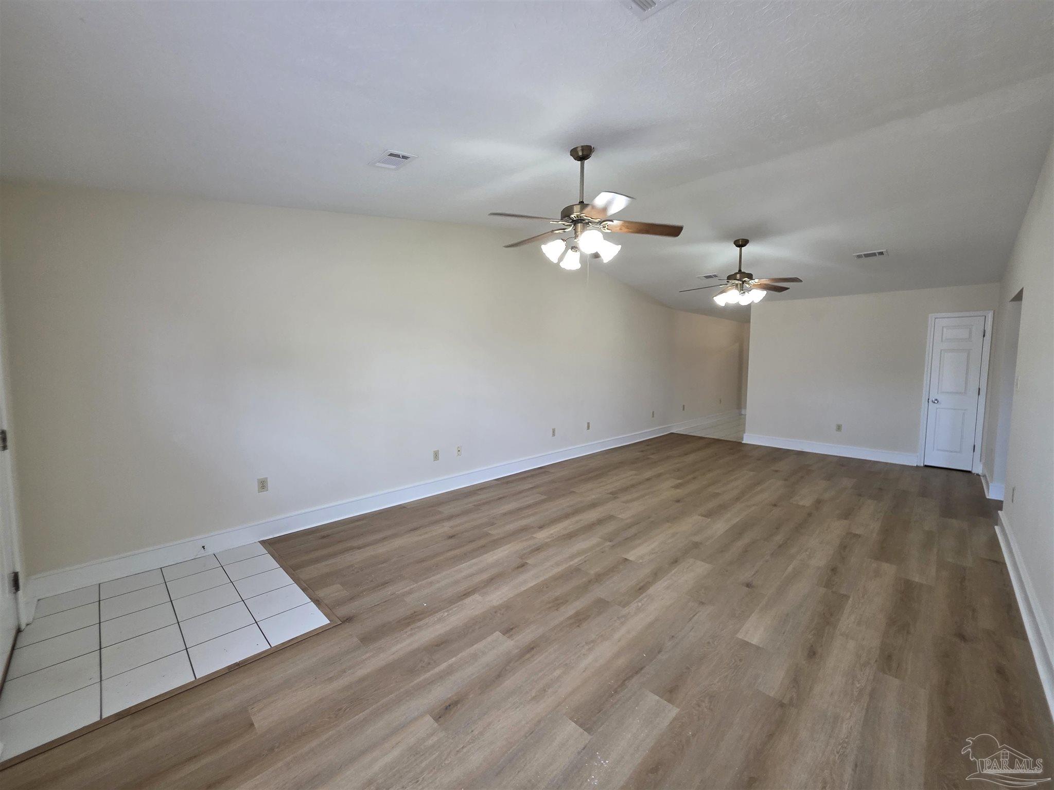 916 Rentz Avenue, Unit A Pensacola, FL 32507 - Photo 3 of 22 wooden floor in an empty room