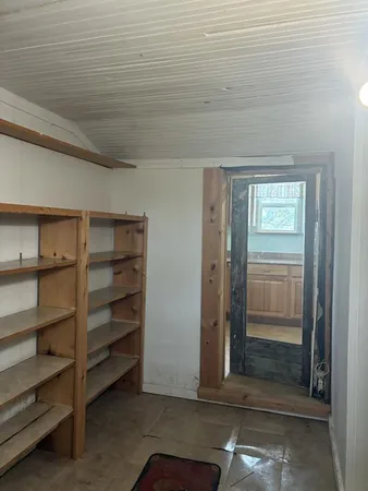 a view of walk in closet with empty racks