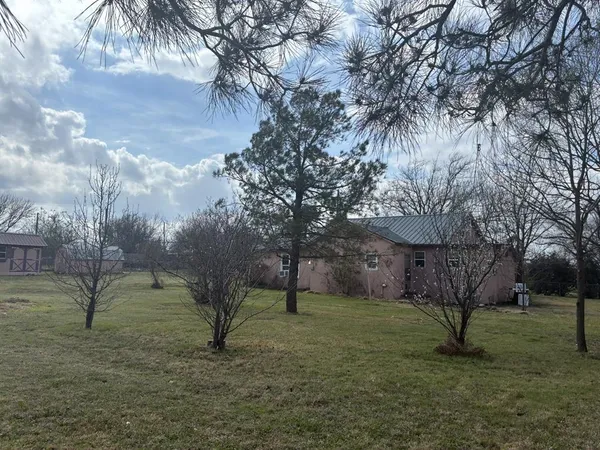 a backyard of a house with table and chairs